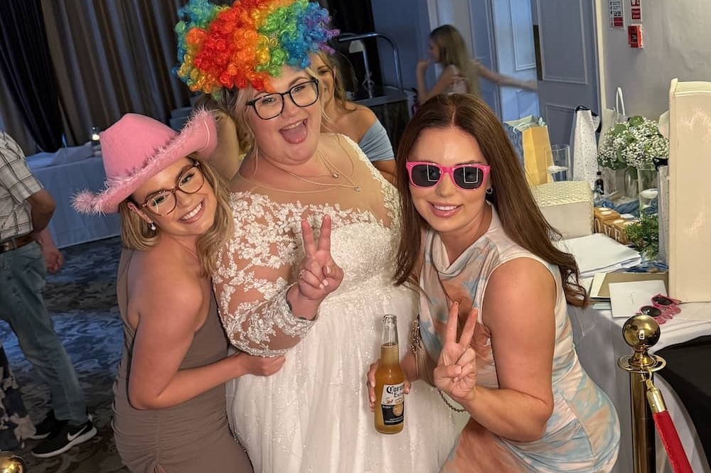 Wedding guests laughing beside the Magic Mirror at The Bridge Hotel & Spa