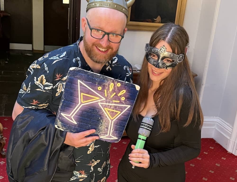 Wedding guests posing with props at Cave Castle Magic Mirror