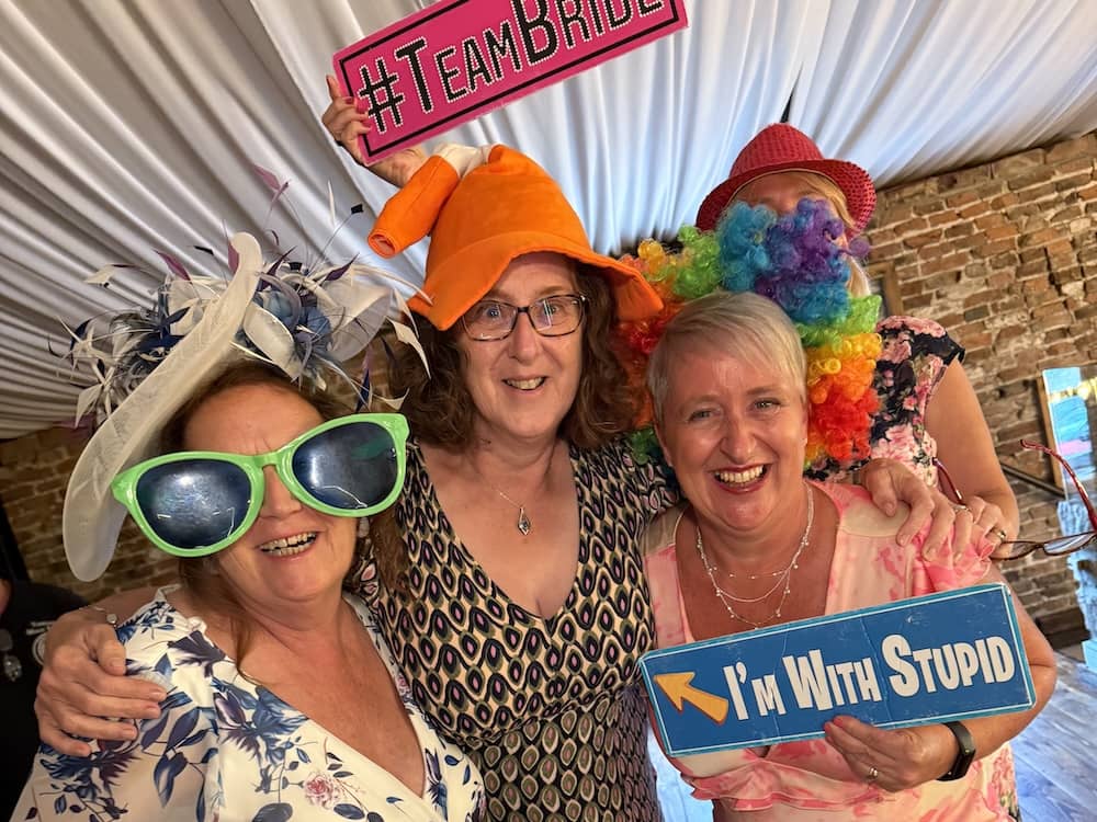 Wedding guests using props at Hornington Manor Magic Mirror