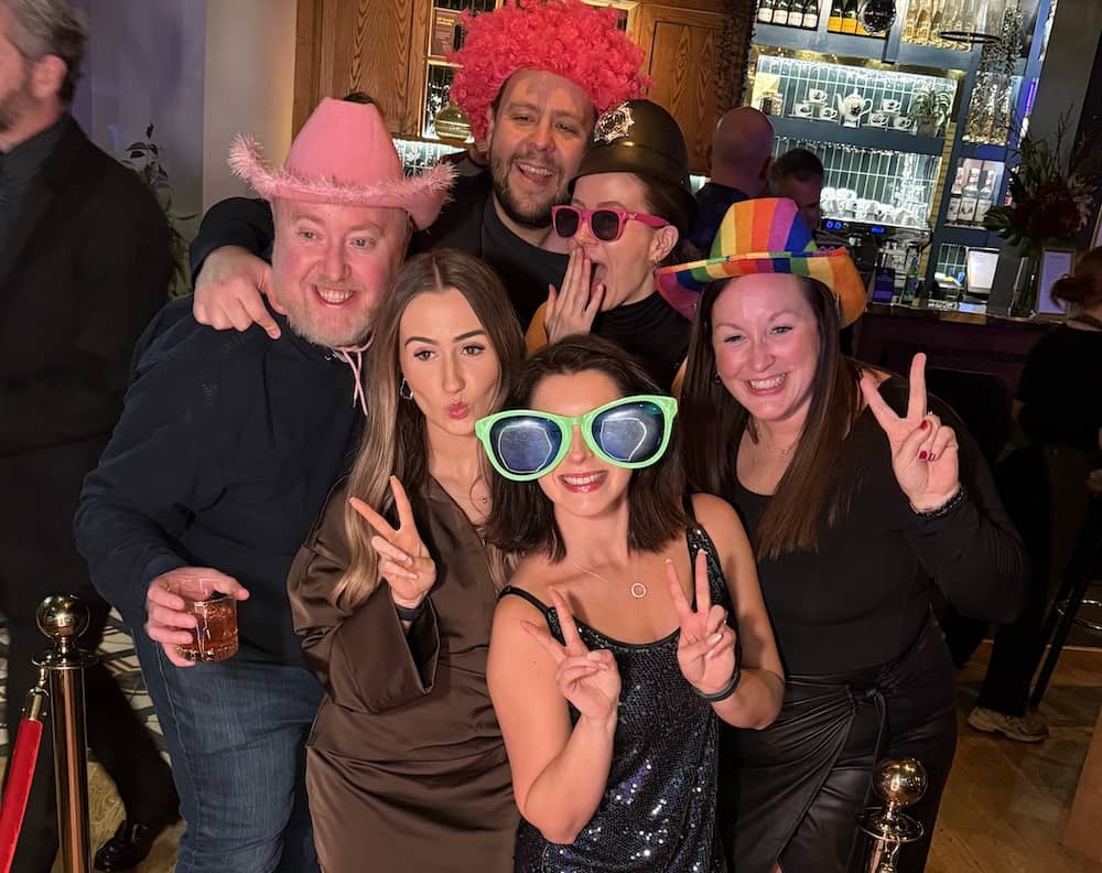 Evri team posing with oversized glasses at Magic Mirror in All Bar One Leeds