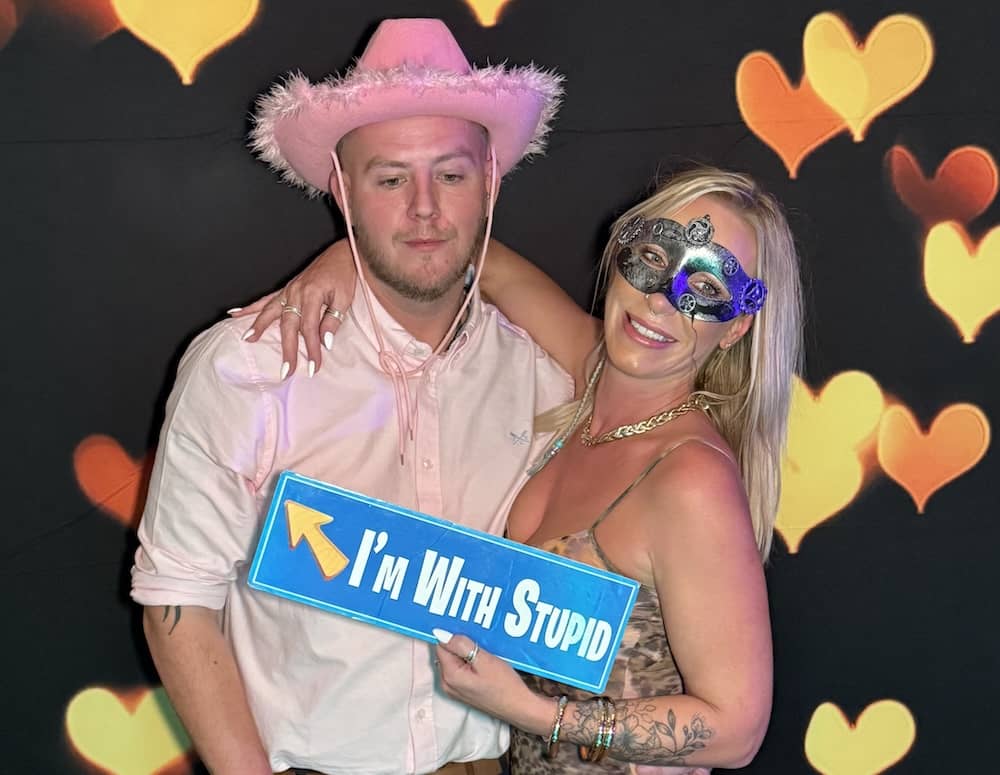 Guests posing with props in front of heart backdrop at Bagden Hall Hotel
