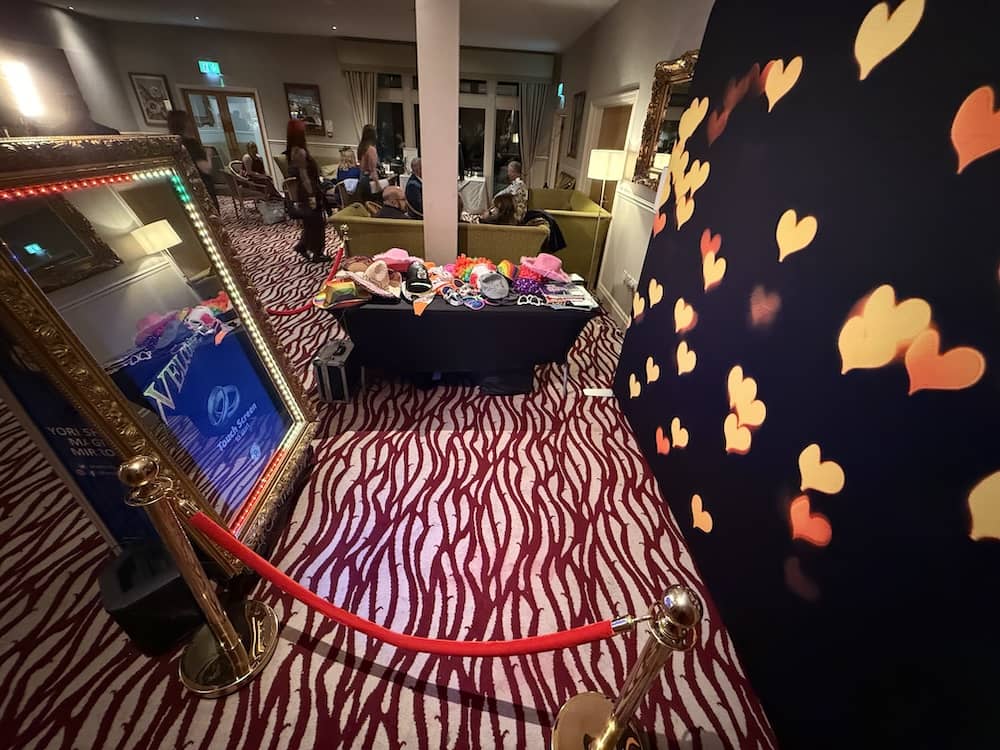 Magic Mirror setup at Bagden Hall Hotel with heart backdrop and props table